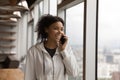 Smiling African American woman talk on smartphone Royalty Free Stock Photo