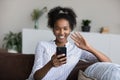 Smiling African American woman talk on webcam call on smartphone Royalty Free Stock Photo