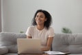 Smiling African American woman using laptop, chatting online, having fun Royalty Free Stock Photo