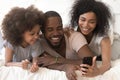 Smiling african american woman taking selfie photo of happy family.