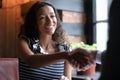 Smiling biracial woman handshake colleague at cafe meeting Royalty Free Stock Photo