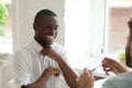 Smiling African American laughing while talking to colleague