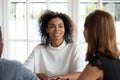 Smiling african american young businesswoman talking with diverse clients. Royalty Free Stock Photo