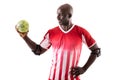 Smiling african american young male handball athlete looking at ball against white background Royalty Free Stock Photo