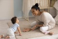 Happy biracial mom paly with baby toddler at home Royalty Free Stock Photo