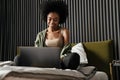 Smiling african american young woman using laptop Royalty Free Stock Photo