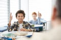 Smiling African Boy Raising Hand in School Royalty Free Stock Photo