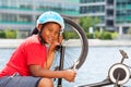 Smiling African boy repairing his bicycle outdoors Royalty Free Stock Photo