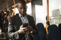 Smiling African businessman listening to music during his morning commute Royalty Free Stock Photo