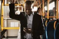 Smiling African businessman standing on a bus listening to music Royalty Free Stock Photo