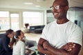 Smiling African businessman standing confidently in an office Royalty Free Stock Photo