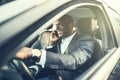 African businessman sitting in a car talking on his cellphone Royalty Free Stock Photo