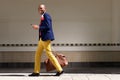 Smiling african businessman walking with bag and phone Royalty Free Stock Photo