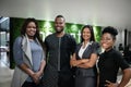 Smiling African businesspeople standing in the lobby of their office