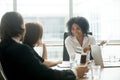 Smiling african american businesswoman discussing business docum