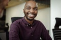 Smiling African businesswoman talking with a colleague in an office Royalty Free Stock Photo