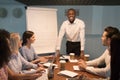 Smiling african coach leader looking at camera at team meeting Royalty Free Stock Photo