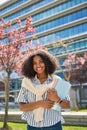 Smiling African girl student in university outdoor campus, vertical portrait. Royalty Free Stock Photo