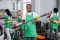 Smiling african man, cleaning service worker, holding vacuum cleaner