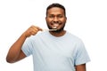 Smiling african man with toothbrush cleaning teeth Royalty Free Stock Photo