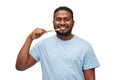 Smiling african man with toothbrush cleaning teeth Royalty Free Stock Photo