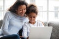 Smiling african mother and kid daughter have fun with laptop Royalty Free Stock Photo