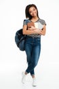 Smiling african teenager girl wearing backpack and holding books Royalty Free Stock Photo
