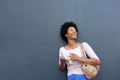 Smiling african woman holding a drink and cellphone Royalty Free Stock Photo