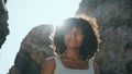 Smiling african woman standing rocky Ursa beach lighted sunlight close up. Royalty Free Stock Photo