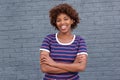 Smiling african woman in striped shirt smiling against gray wall Royalty Free Stock Photo