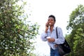 Smiling african woman walking and talking with cell phone Royalty Free Stock Photo