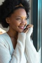 Smiling afro african american young woman looking away at home Royalty Free Stock Photo