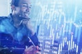 Smiling Afro-American business man or stock trader analyzing sto Royalty Free Stock Photo