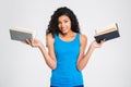 Smiling afro american woman holding two books Royalty Free Stock Photo