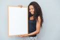 Smiling afro american woman showing blank board Royalty Free Stock Photo