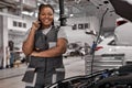 Smiling afro Female auto repair worker, having a break, looking at camera