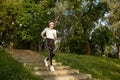 Smiling aged elderly woman jogging outdoors enjoying healthy lifestyle Royalty Free Stock Photo