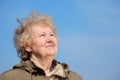 Smiling aged woman look in sky