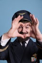 Smiling airliner pilot showing heart shaped love symbol