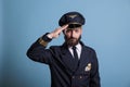 Smiling airplane aviator saluting,