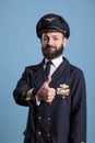 Smiling airplane aviator showing thumb up gesture