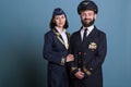 Smiling airplane captain and flight attendant