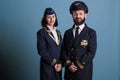 Smiling airplane pilot and flight attendant in uniform portrait