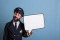 Smiling airplane pilot holding white blank speech bubble Royalty Free Stock Photo
