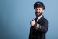 Smiling airplane pilot showing thumb up gesture