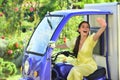Smiling amazed young woman draver in electro car. Saving ecology. Electric cars.