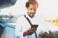 Smiling American African man using smartphone to call his friends at sunny city while his brake.Concept of happy young Royalty Free Stock Photo