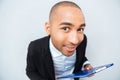 Smiling amusing african american young man holding clipboard