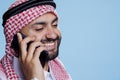 Smiling arab answering smartphone call Royalty Free Stock Photo