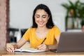 Smiling arab girl working online at cafe